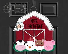 a barn door hanger with three farm animals hanging from it's side and the words mrs laweng on top