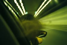 a blurry photo of a person riding on a bus in the city at night