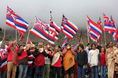 a group of people standing next to each other holding flags