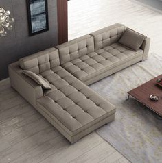 a living room with a couch, coffee table and rug on the floor in front of it