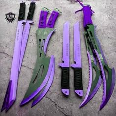 purple and green knifes are laying on the ground