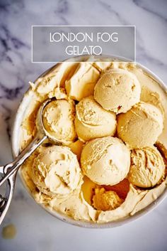 a bowl filled with ice cream next to a spoon