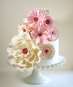 a white cake with pink and yellow flowers on top