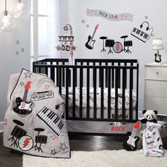 a baby's room decorated in black and white with musical instruments on the wall