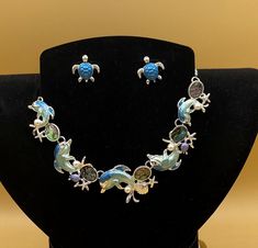 "Blue dolphins and turtle bib statement necklace & earring set.  This is the perfect beach, summer or tropical cruise jewelry.    Optional matching bracelet available.  Each piece has a custom length to fit all sizes.  Necklace is made from glass pearls, abalone and crystals to form a unique and stylish look.  I can convert any of the earrings from pierced to clip on style at no charge, please request this in notes with purchase.  Please do not hesitate to contact me with any questions, I would Adjustable Ocean-inspired Metal Jewelry, Ocean-inspired Multicolor Jewelry Gift, Cruise Jewelry, Tropical Cruise, Art Deco Pendant, Matching Bracelets, Necklace Earring Set, Chain Styles, Earring Set