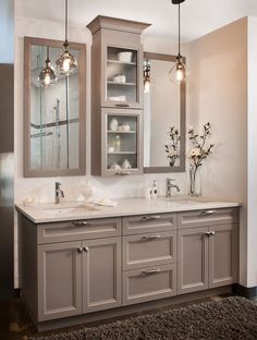 a bathroom with double sinks and two large mirrors on the wall above them is shown