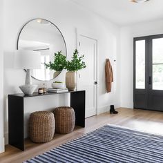 a room with a large mirror and two stools on the floor next to it