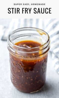 a jar filled with homemade stir fry sauce on top of a white tablecloth and text overlay reads, super easy homemade stir fry fry sauce