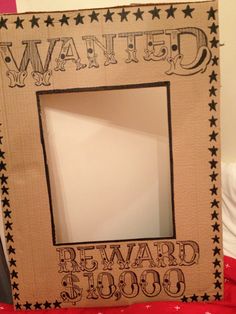 a cardboard photo frame that says wanted reward $ 1, 000 with stars on it