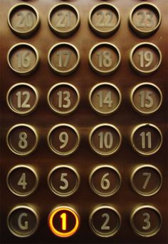 an elevator with numbers on it and the number 1 in front of them is lit up