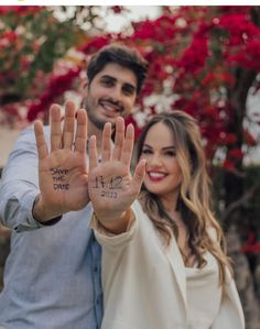 a man and woman holding up their hands with the words love written on each hand