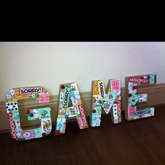 the letters are made out of different types of stickers and paper machs,