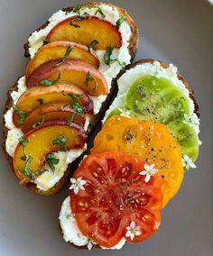 an open face sandwich with tomatoes, avocado, and other toppings on it