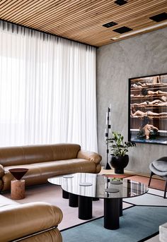 a living room filled with furniture and a flat screen tv mounted to the side of a wall