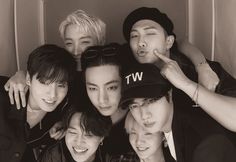 black and white photo of group of young men posing for camera with one pointing at the camera