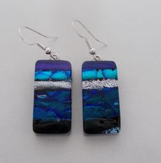 I fused 2 layers of glass to create this gorgeous earring ,,dichroic glass and clear glass on the top. The size is 1/2" by 1 " .All my jewelry come in a nice gift box. Iridescent Ear Wire Earrings For Gift, Clear Glass Earrings As A Gift, Silver Czech Glass Earrings As Gift, Silver Czech Glass Earrings For Gift, Clear Glass Earrings For Gifts, Clear Glass Earrings For Gift, Iridescent Nickel-free Earrings As A Gift, Iridescent Glass Earrings For Gift, Iridescent Czech Glass Jewelry For Gift