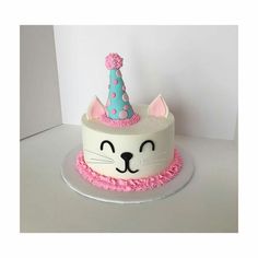 a birthday cake with a cat hat on top