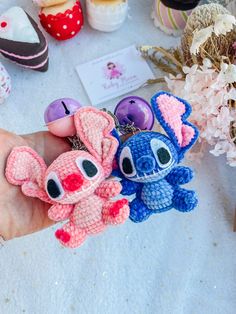 two small crocheted keychains in the palm of someone's hand