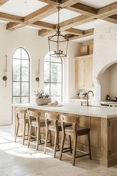 a large kitchen with an island counter top and stools in front of the stove