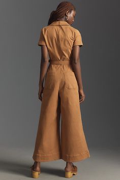 71% cotton, 26% Tencel, 3% elastane Cropped inseam Front and back patch pockets Belted styling Back zip Machine wash Imported | Wrapped Culotte Jumpsuit by Maeve in Beige, Women's, Size: 10, Cotton/Elastane/Tencel at Anthropologie Cotton Fitted Jumpsuits And Rompers With Pockets, Fitted Cotton Jumpsuits And Rompers With Pockets, Fitted Jumpsuits And Rompers With Patch Pockets For Spring, Chic Cotton Jumpsuits And Rompers For Work, Chic Cotton Jumpsuits For Work, Summer Jumpsuits And Rompers With Patch Pockets, Fitted Jumpsuits And Rompers With Side Pockets For Work, Chic Fitted Cotton Jumpsuits And Rompers, Beige Jumpsuit