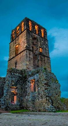 an old stone building lit up at night