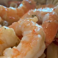 closeup of shrimp and pasta with sauce on it