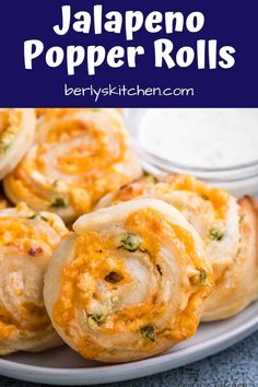 jalapeno popper rolls on a plate with dipping sauce in the background