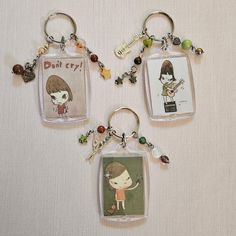 three key chains with cartoon characters on them