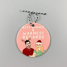 a pink christmas ornament with the words best wishes and warmest records on it