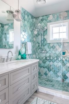 a bathroom with blue and white tiles on the walls