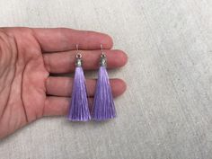 "Chic light purple tassel earrings! They would add a pop of color to any outfit for any occasion. Dress them up or down. They are timeless and versatile. They are lightweight, fun and unique! The tassels measure 2 1/8\" long by 1/4\" wide. They hang from simple silver ear wire hooks. Overall drop length is about 2 1/4\". Metal is allergy free plated silver. These are my latest creation! I have them available in many colors! Find them all under the category tassel earrings in my shop. Thanks for Purple Dangle Tassel Earrings, Purple Dangle Earrings With Tassels, Handmade Purple Tassel Earrings For Gift, Handmade Purple Tassel Earrings As Gift, Lavender Jewelry, Lavender Jewellery, Purple Earrings, Ethnic Earrings, Unique Jewelry Designs