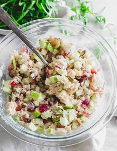 a glass bowl filled with salad on top of a table