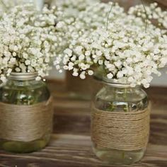 three mason jars filled with baby's breath flowers