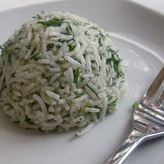 a white plate topped with rice and a fork