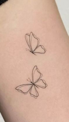 two butterflies on the back of a woman's thigh