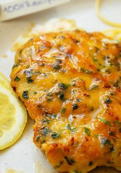 a close up of a piece of food with broccoli and lemon on the side