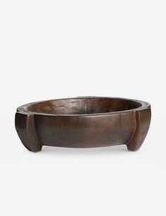 a wooden bowl sitting on top of a white surface