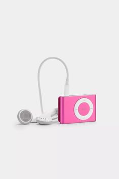 a pink ipod with headphones attached to it's earpieces on a white surface