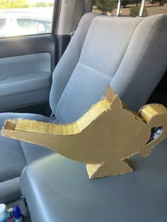 a cardboard cut out of a bird sitting in the back seat of a car,