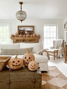 a living room filled with furniture covered in carved pumpkins