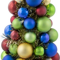 a multicolored christmas tree with balls and tinsel on the top, against a white background