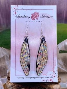 a pair of earrings sitting on top of a card