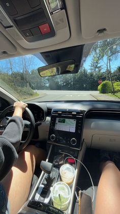 a person driving a car with their hands on the steering wheel