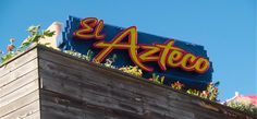 a sign on top of a building that says el arteco in spanish and english