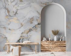 a white and gold marbled wall in a living room with a bench next to it