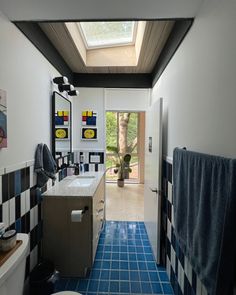 a bathroom with blue and white tiles on the floor