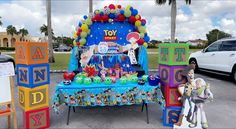 a toy story birthday party with cars and toys in the parking lot next to it