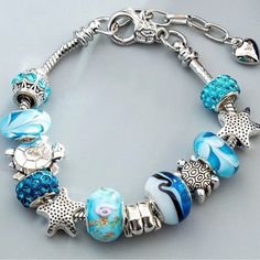 Boutique Item Beautiful European Charm Bracelet Sea Turtle , Star Fish, Sea Shell, Charms With Glass Beads And Rhinestone Beads. Very Nice Clasp! Very Good Quality! Very Beautiful! 2 Cute Blue Charm Bracelets For The Beach, Silver Beaded Star Bracelets, Ocean-inspired Charm Bracelet Gift, Ocean-inspired Charm Bracelet As A Gift, Blue Beaded Star-shaped Bracelets, Blue Star-shaped Jewelry With Colorful Beads, Ocean-inspired Blue Charm Bracelet For Gifts, Beach Ocean-inspired Charm Bracelet, Leather Wrist Cuff