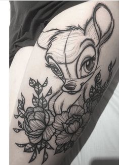 a woman's thigh with a deer tattoo on it