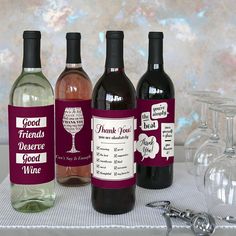 three wine bottles with labels on them sitting next to some wine glasses and corks